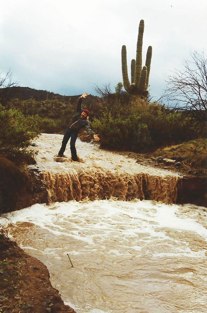 image of Richard Mocco standing in the washed out driveway at Harmony Hollow in Arizona