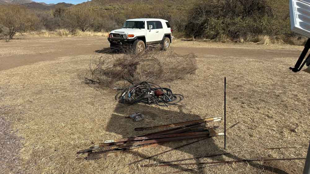 image of pile of fencing and trash removed from harmony hollow drivweway